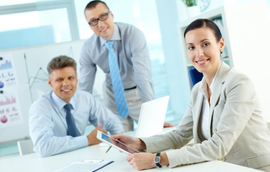 Portrait of pretty lady looking at camera in working environment in office